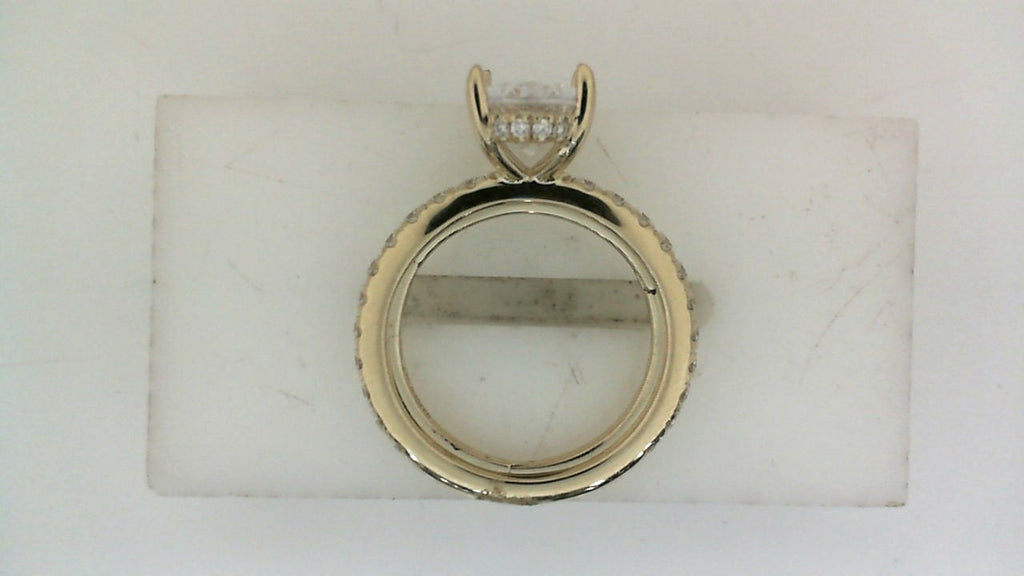 Yellow gold ring with round diamond accents.