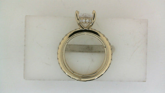 Yellow gold ring with round diamond accents.