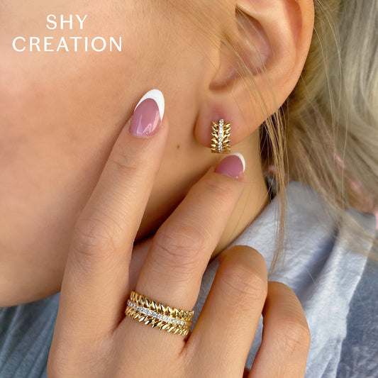 Yellow gold huggie earrings with diamonds.