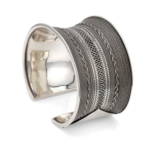 Sterling silver cuff with intricate woven patterns.