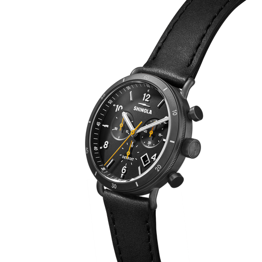 Black dial chronograph watch with leather strap.