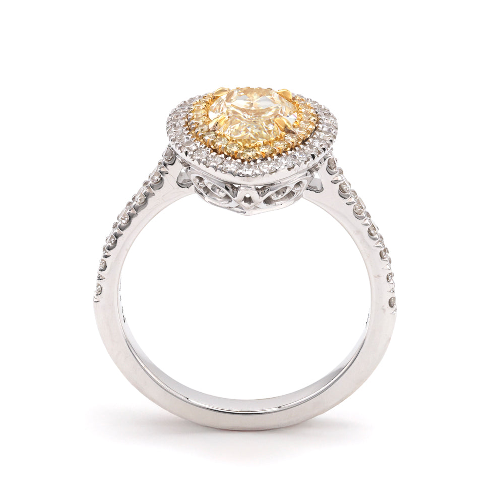 Yellow pear diamond halo engagement ring.
