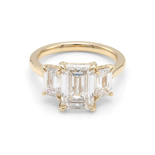 Three-stone yellow gold engagement ring.