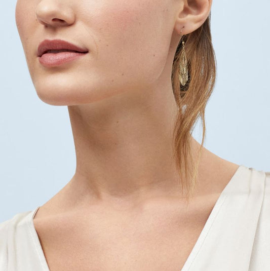 Gold knot earrings with nugget finish.