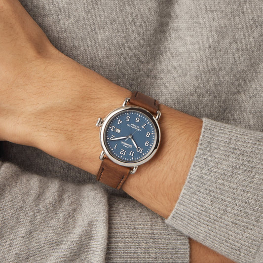 Blue dial, stainless steel, brown leather watch.