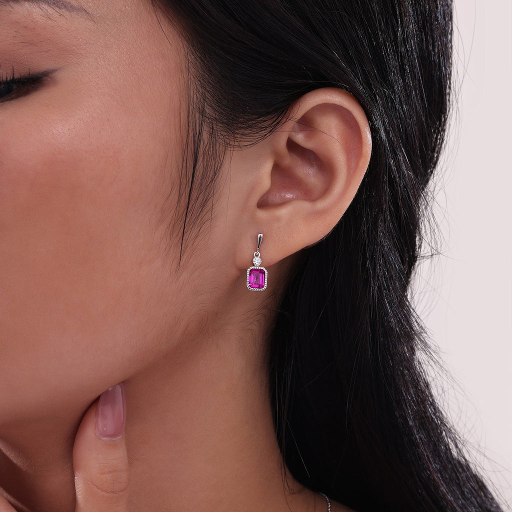 Emerald-cut ruby earrings with diamond accents.