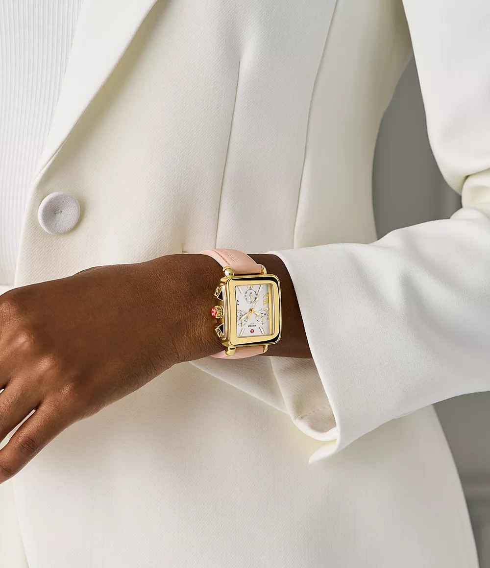 Gold-plated watch with pink silicone band.