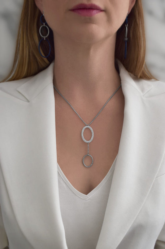 Diamond necklace with interlocking oval pendants.