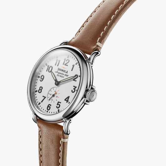 White dial, stainless steel case, brown leather band.