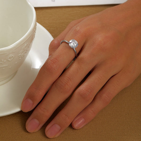 Simulated diamond ring on finger.