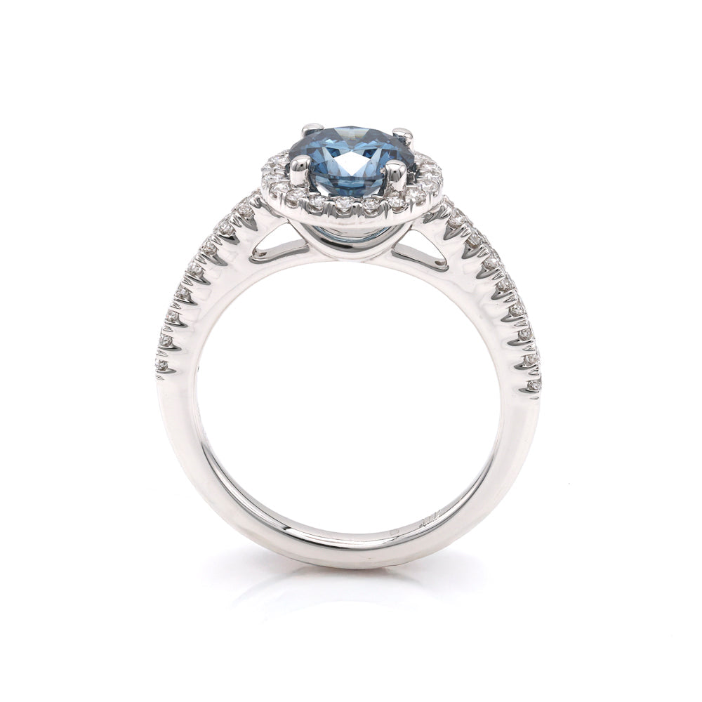 Blue diamond halo engagement ring in white gold.