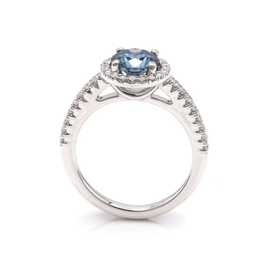 Blue diamond halo engagement ring in white gold.