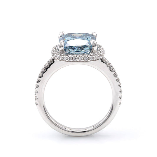 Blue diamond halo engagement ring in white gold.