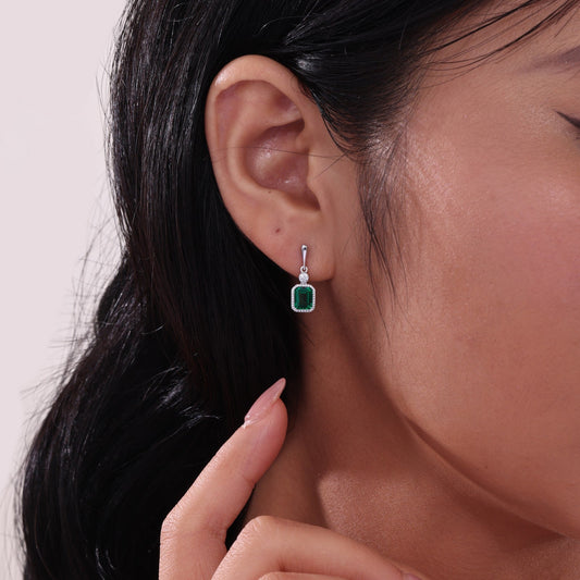 Simulated emerald earrings in platinum silver.