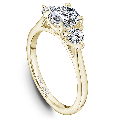 Three-stone yellow gold diamond engagement ring.