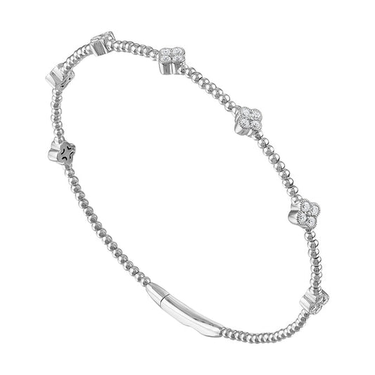 Flexible bangle with round diamonds in white gold.