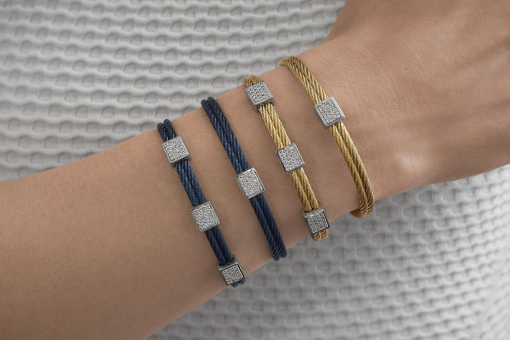 Yellow and blue cable bracelets with diamonds.