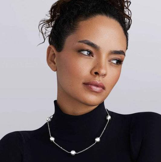 Sterling silver station necklace with beads.