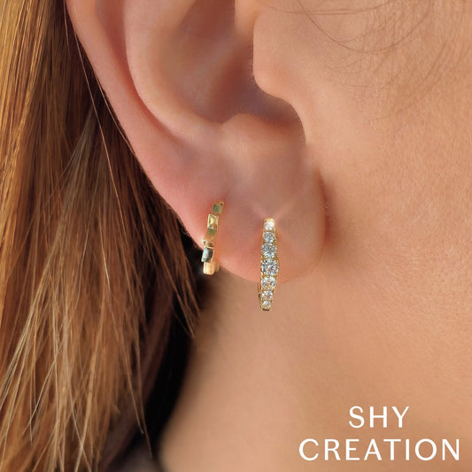 14K white gold diamond huggie earrings.