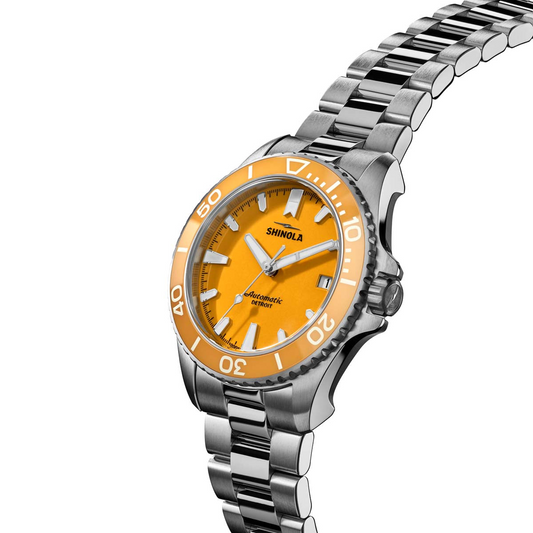 Yellow dial stainless steel dive watch.