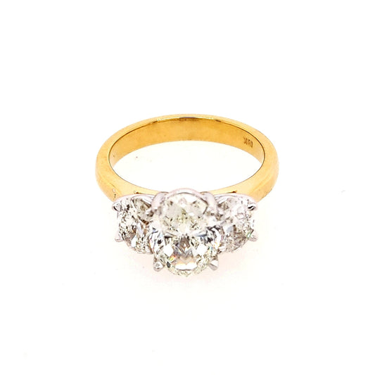 Three-stone oval diamond yellow gold ring.