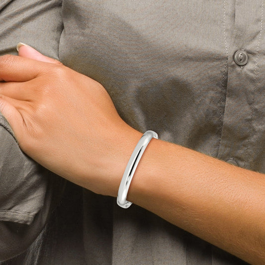 Sterling silver minimalist bangle on wrist.