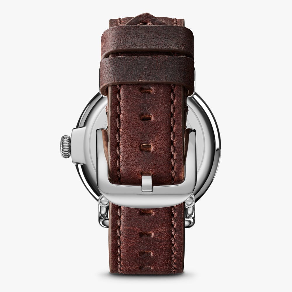 Brown leather watch strap with silver buckle.