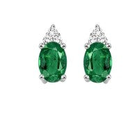Oval emerald stud earrings with diamonds.