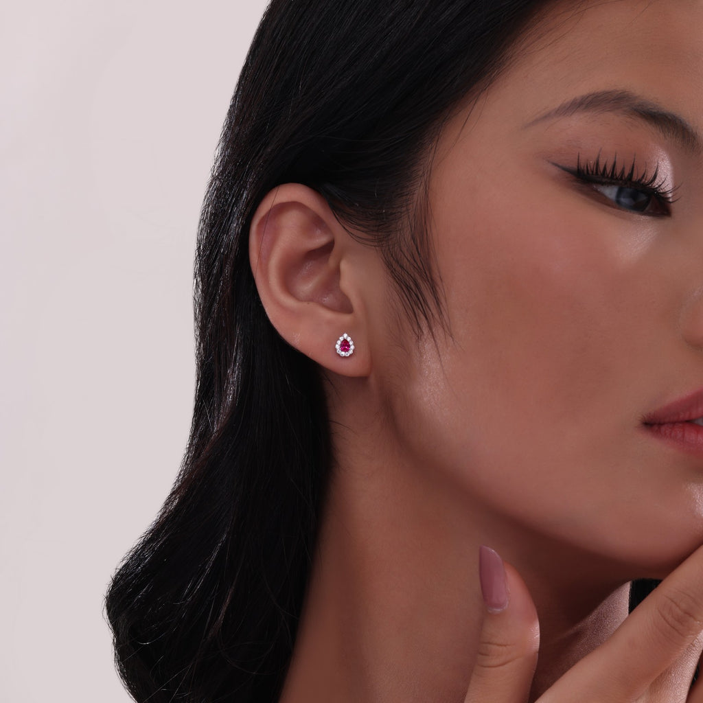 Pear-shaped ruby earrings with diamond halo.