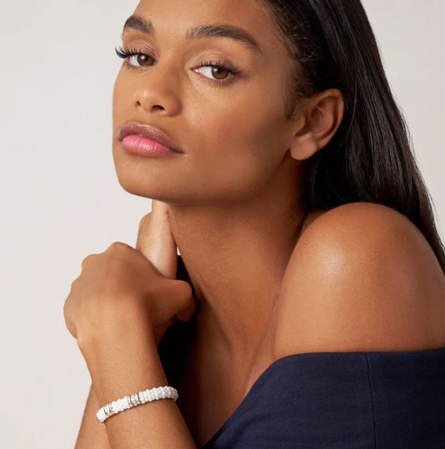 White ceramic diamond bracelet on wrist.