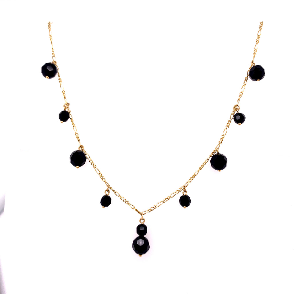 14K yellow gold necklace with black gemstones.