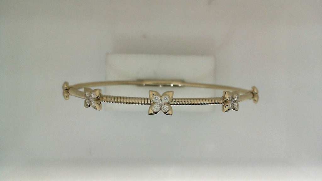 Yellow gold bracelet with diamond flower accents.