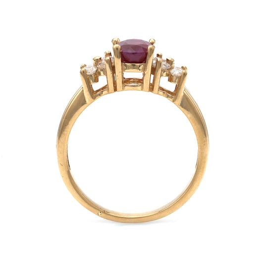 18K gold ring with oval ruby centerpiece.