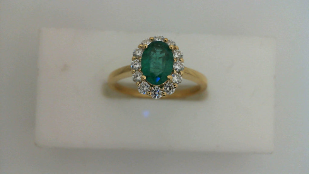Oval emerald ring with diamond halo.