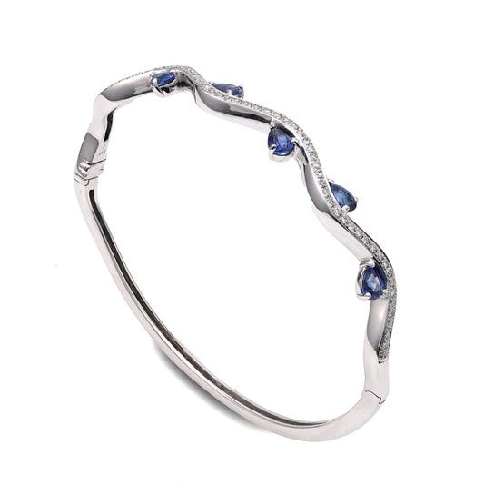 18K white gold bangle with pear sapphires.