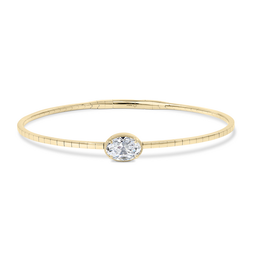 Oval diamond yellow gold bangle bracelet.