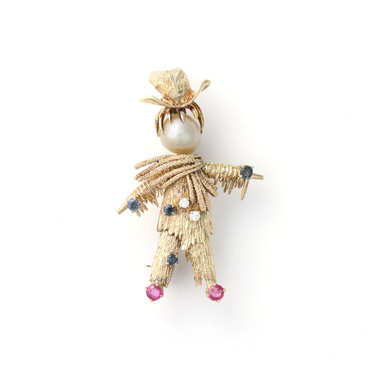 Scarecrow pin with pearl, sapphires, rubies, diamonds.