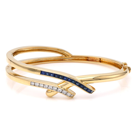 18K gold bangle with diamonds, sapphires.