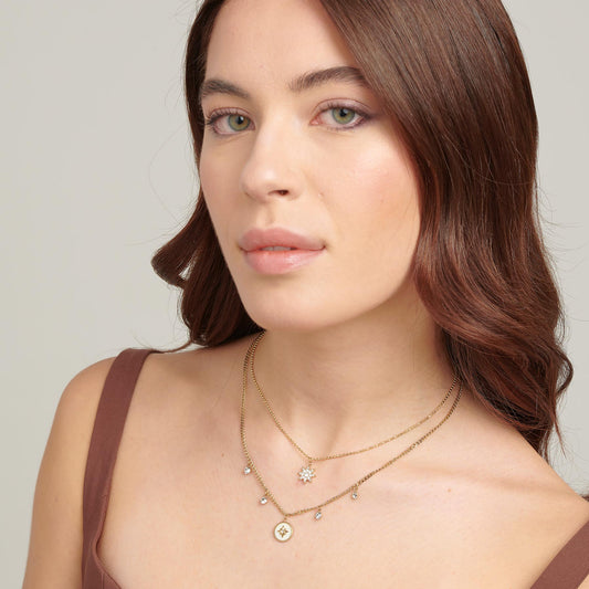 Multi-strand yellow chain with diamond pendant.
