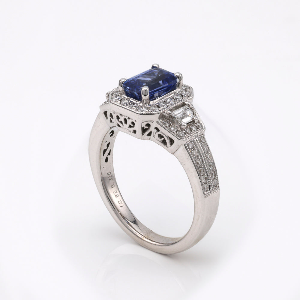 Emerald sapphire ring with diamond accents.