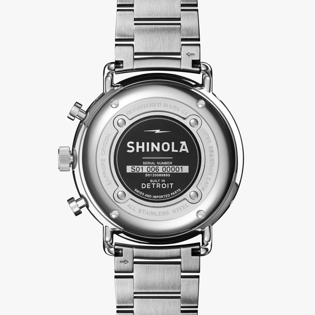 Stainless steel chronograph watch back view.