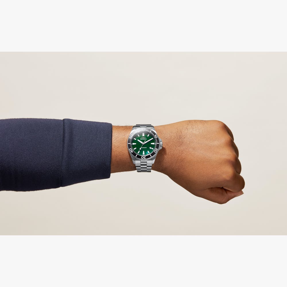 Green dial stainless steel dive watch.