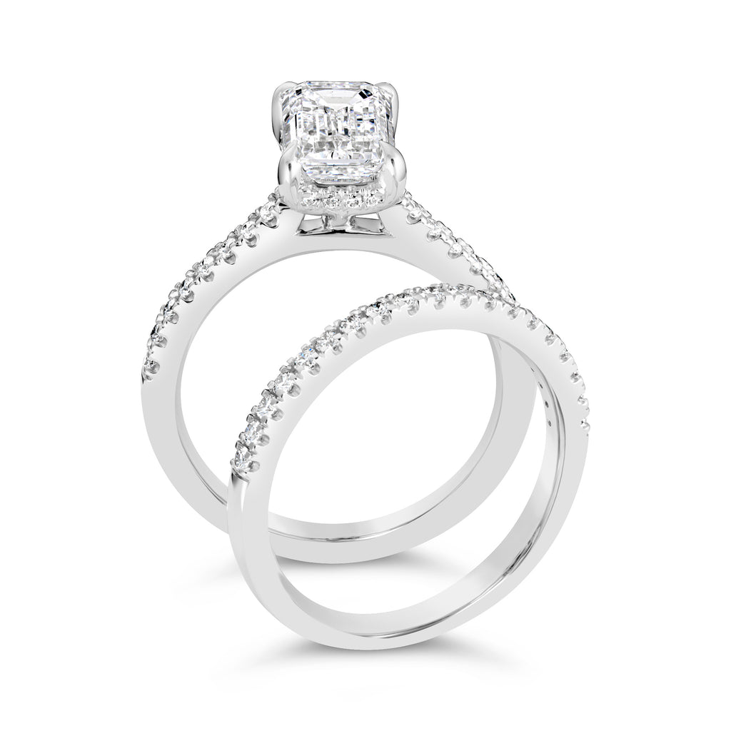 Emerald-cut diamond ring with side accents.