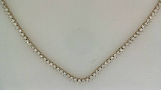 Round diamond tennis necklace in yellow gold.
