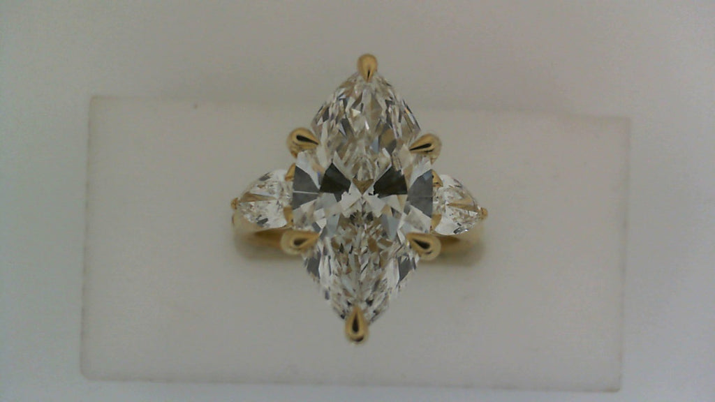 Three-stone marquise diamond ring in gold.