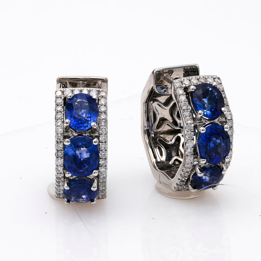 18K white gold earrings with oval sapphires.