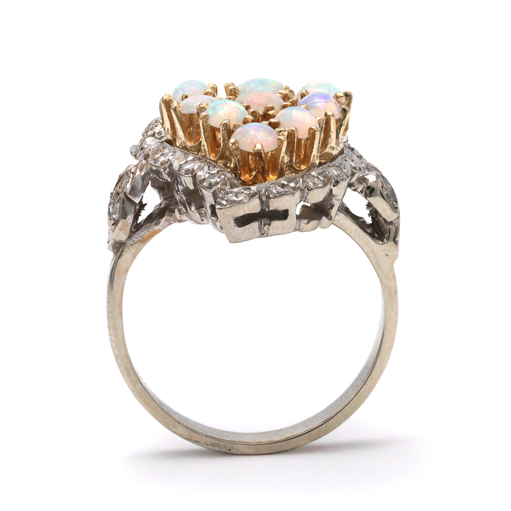 Opal and diamond ring in gold setting.