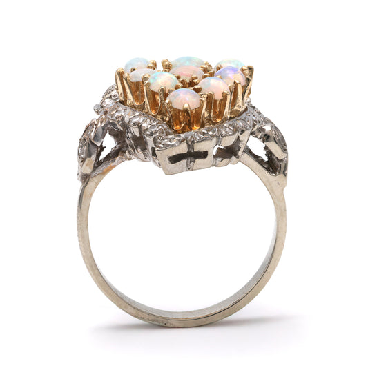 Opal and diamond ring in gold setting.