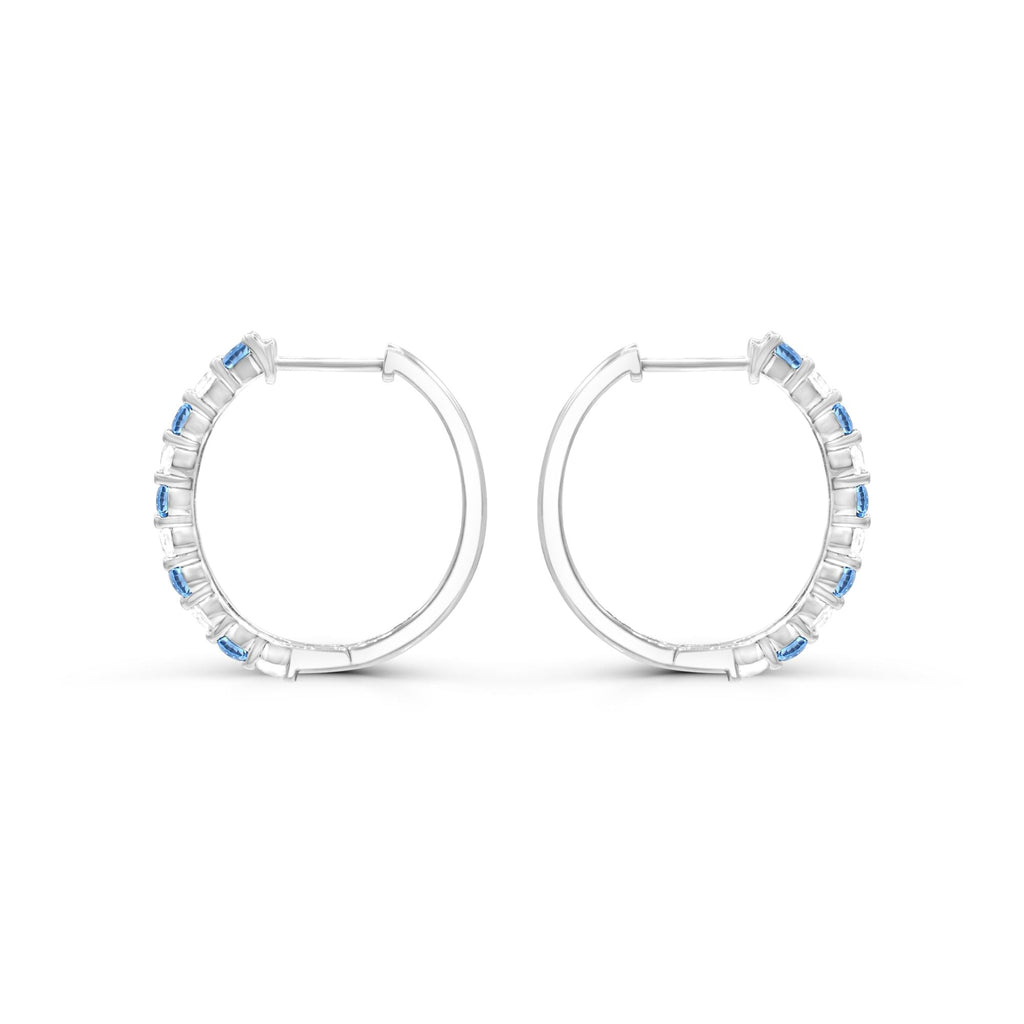 Sterling silver hoops with blue topaz stones.