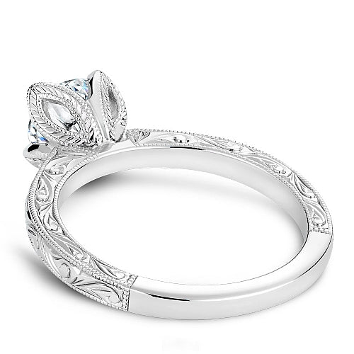 White gold ring with intricate leaf design.